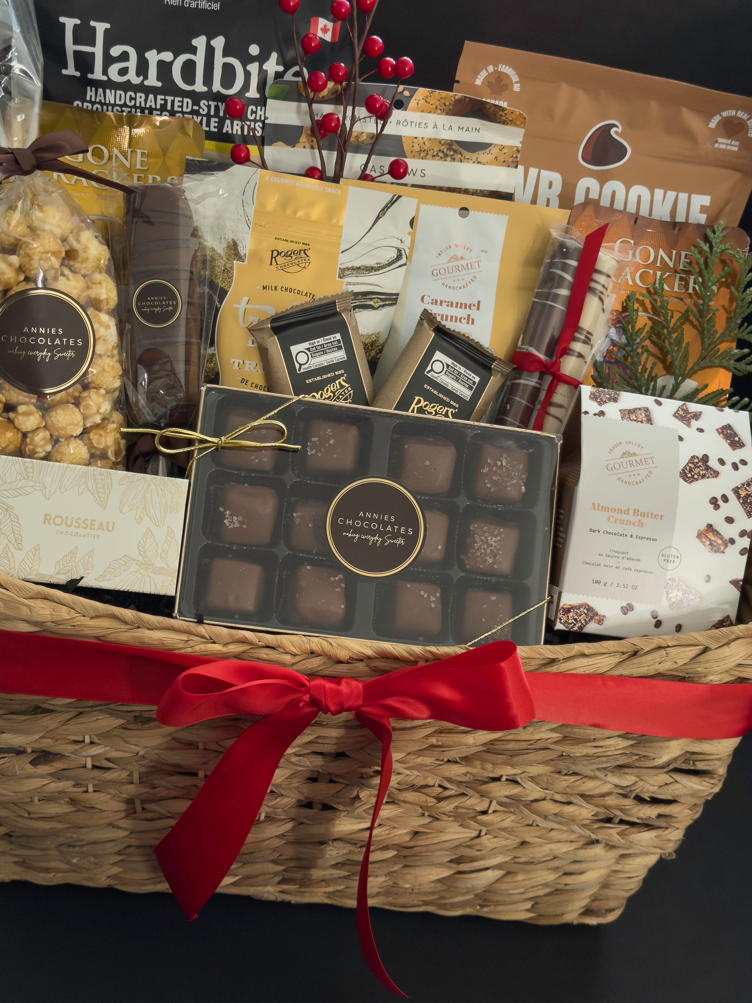 The Holiday Gathering Basket by Muse Baskets and Co. arranged with artisan sweets, savoury snacks, gourmet popcorn and crackers for office holiday celebrations.