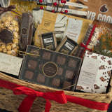 Luxury holiday gift basket by Muse Baskets and Co. with chocolates, caramels, savoury snacks, artisan crackers and satin ribbon for Vancouver holiday gifting.