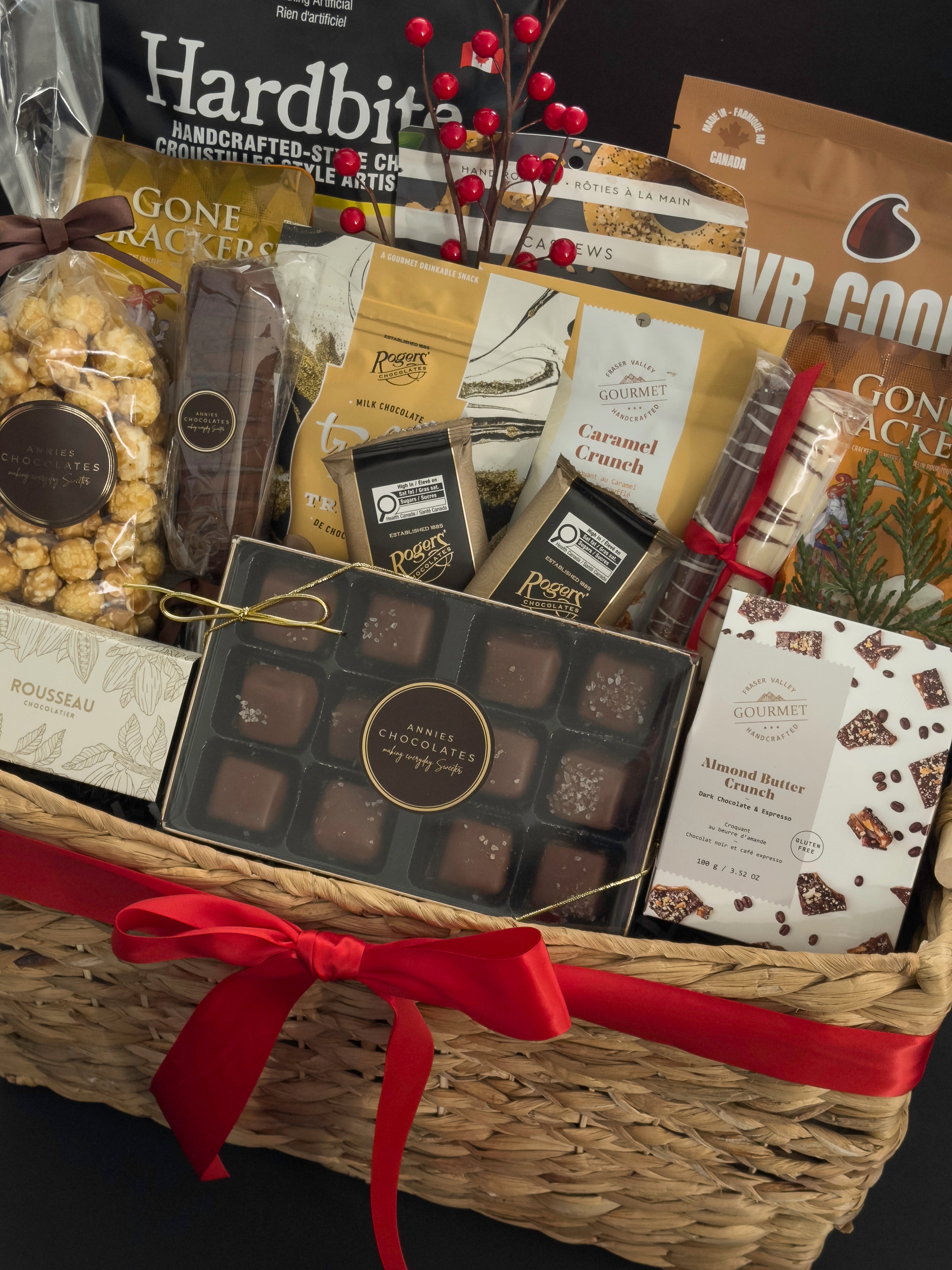 Luxury holiday gift basket by Muse Baskets and Co. with chocolates, caramels, savoury snacks, artisan crackers and satin ribbon for Vancouver holiday gifting.