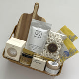 Woven Thanksgiving hostess gift basket by Muse Baskets and Co. with pantry, home and self-care items curated for hosts, clients and homeowners.