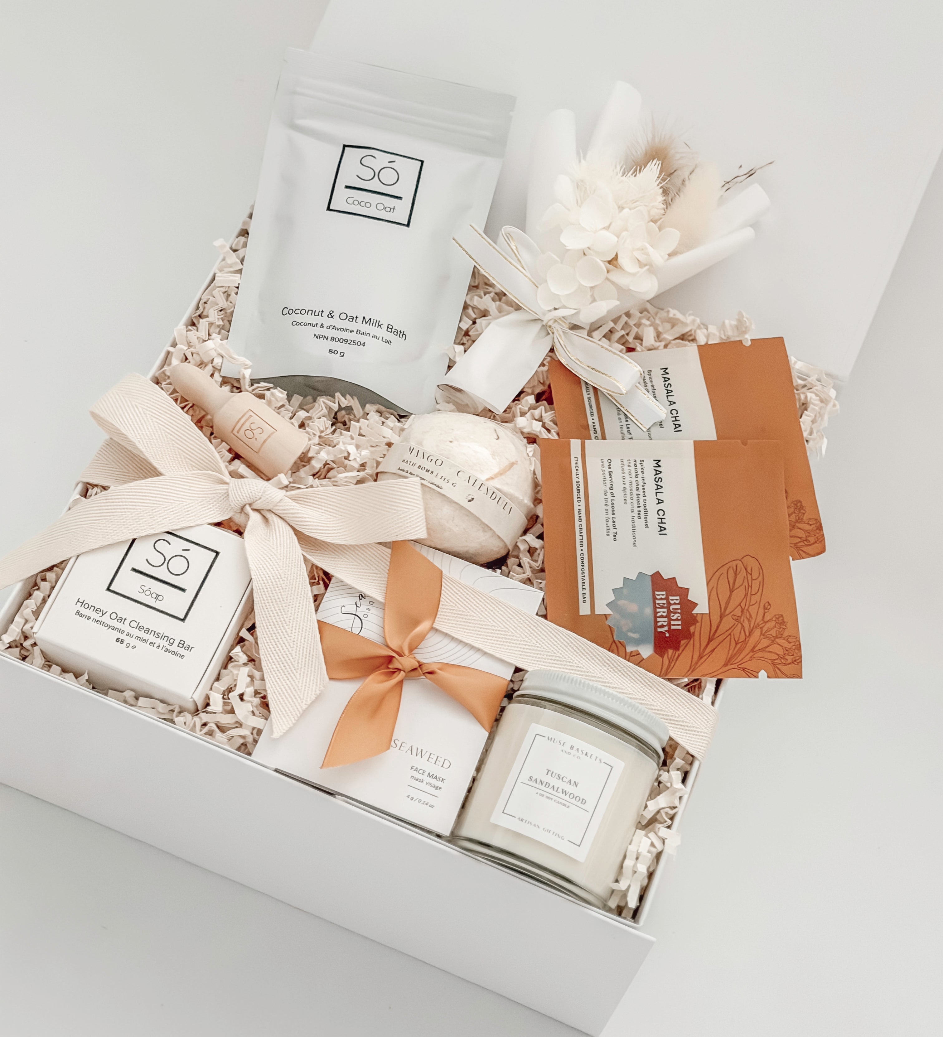 Gift set with bath products including a jar, soap, and bath bombs in a decorative box.