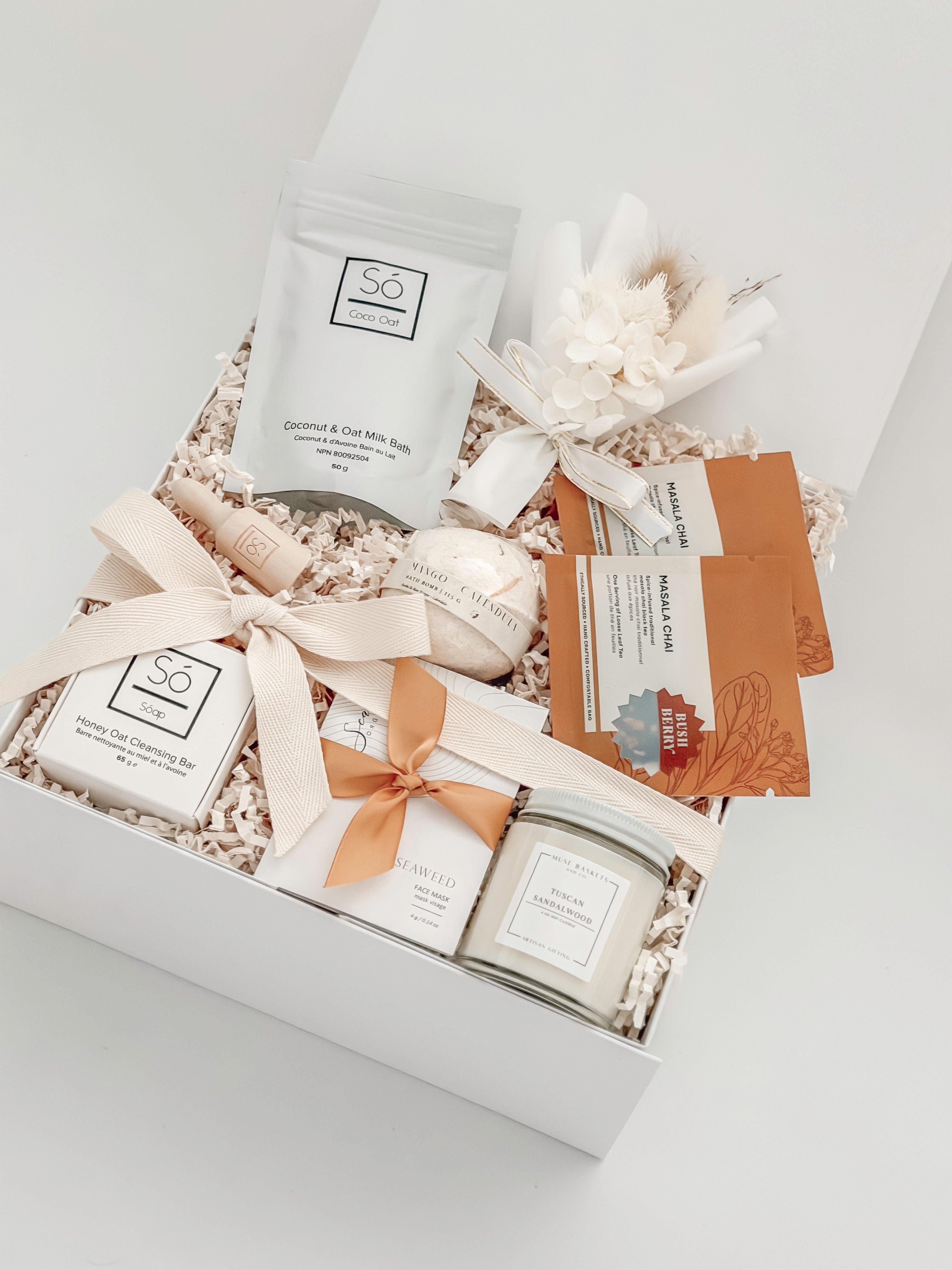 Gift set with bath products including a jar, soap, and bath bombs in a decorative box.