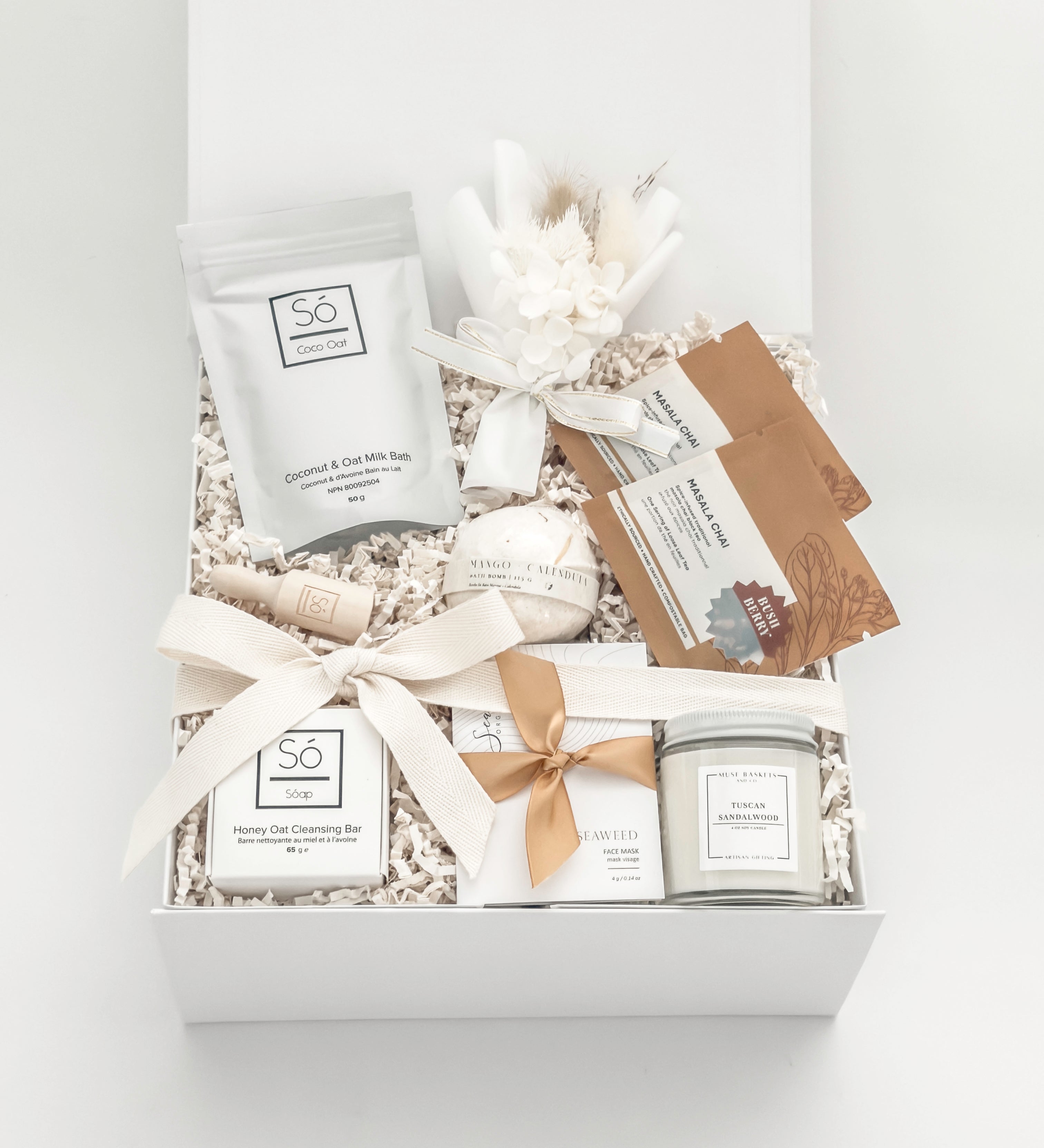 Gift box with skincare products and decorative elements on a white background