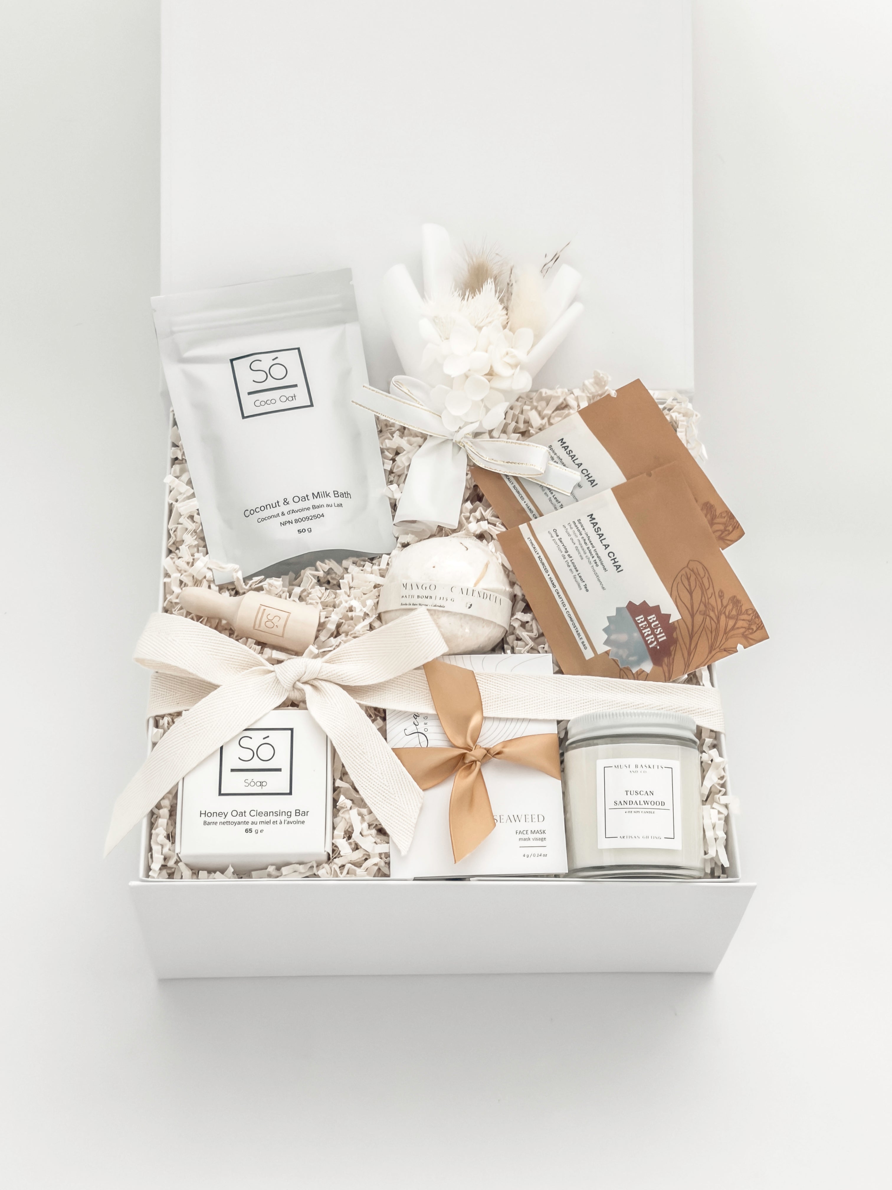 Gift box with skincare products and decorative elements on a white background
