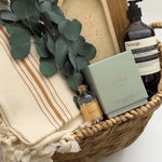 Demeure housewarming gift basket featuring Vancouver Candle Co candle Lynn and Liana wood board and preserved eucalyptus