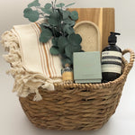Luxury housewarming gift box Demeure by Muse Baskets Vancouver with acacia board travertine tray Turkish throw and Aesop hand wash