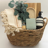 Luxury housewarming gift box Demeure by Muse Baskets Vancouver with acacia board travertine tray Turkish throw and Aesop hand wash