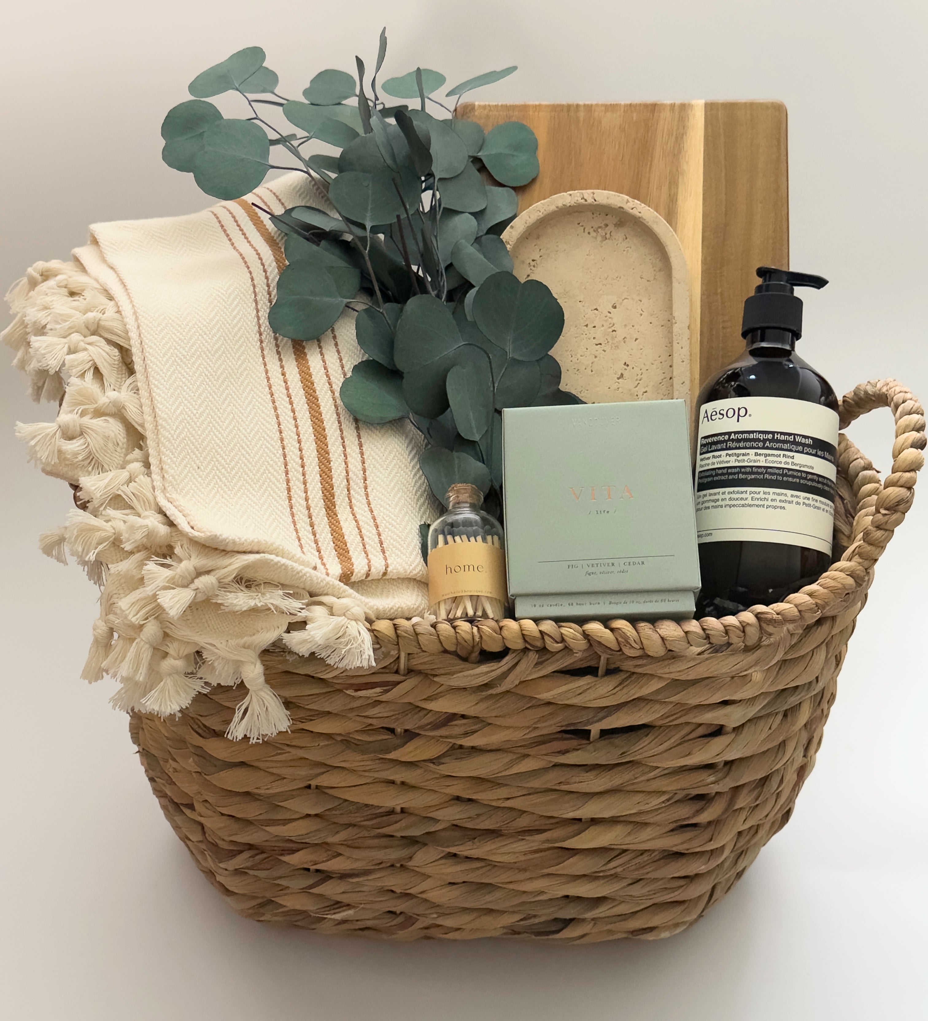 Luxury housewarming gift box Demeure by Muse Baskets Vancouver with acacia board travertine tray Turkish throw and Aesop hand wash
