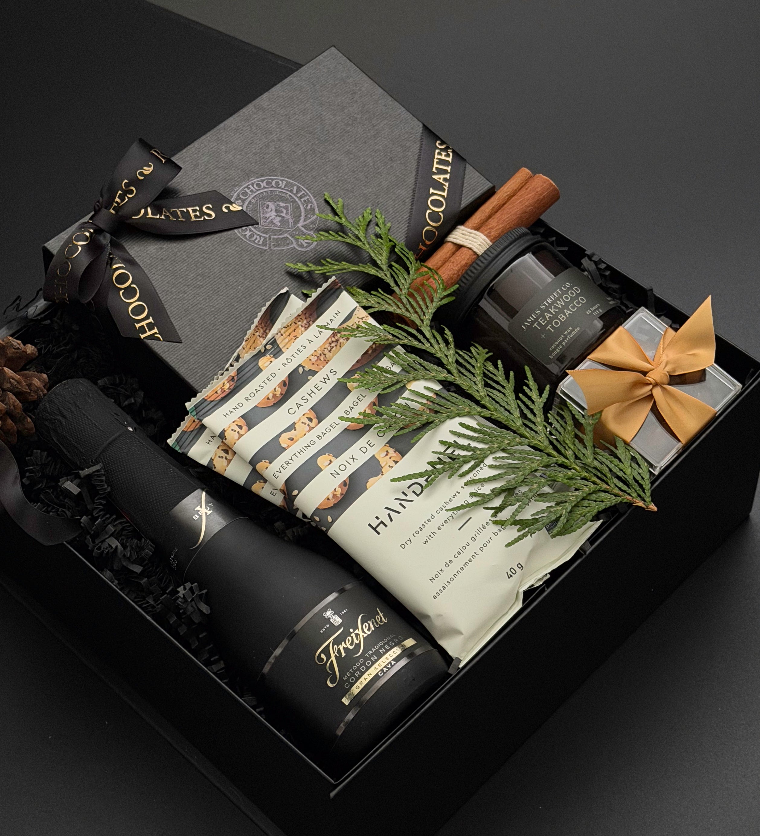 The Marlowe corporate holiday gift box with Canadian chocolates, roasted cashews, boxed almonds and a teakwood tobacco candle.