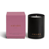 Vancouver Candle Co. Amare candle in peony, jasmine, and ylang ylang, shown beside its pink packaging, a premium candle featured in Muse Baskets and Co. corporate gift baskets
