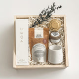 Warm Welcome new homeowner gift with tea, ceramic mug, home fragrance and candle, presented in Muse Baskets and Co.’s Signature Luxe Wood Gift Box.
