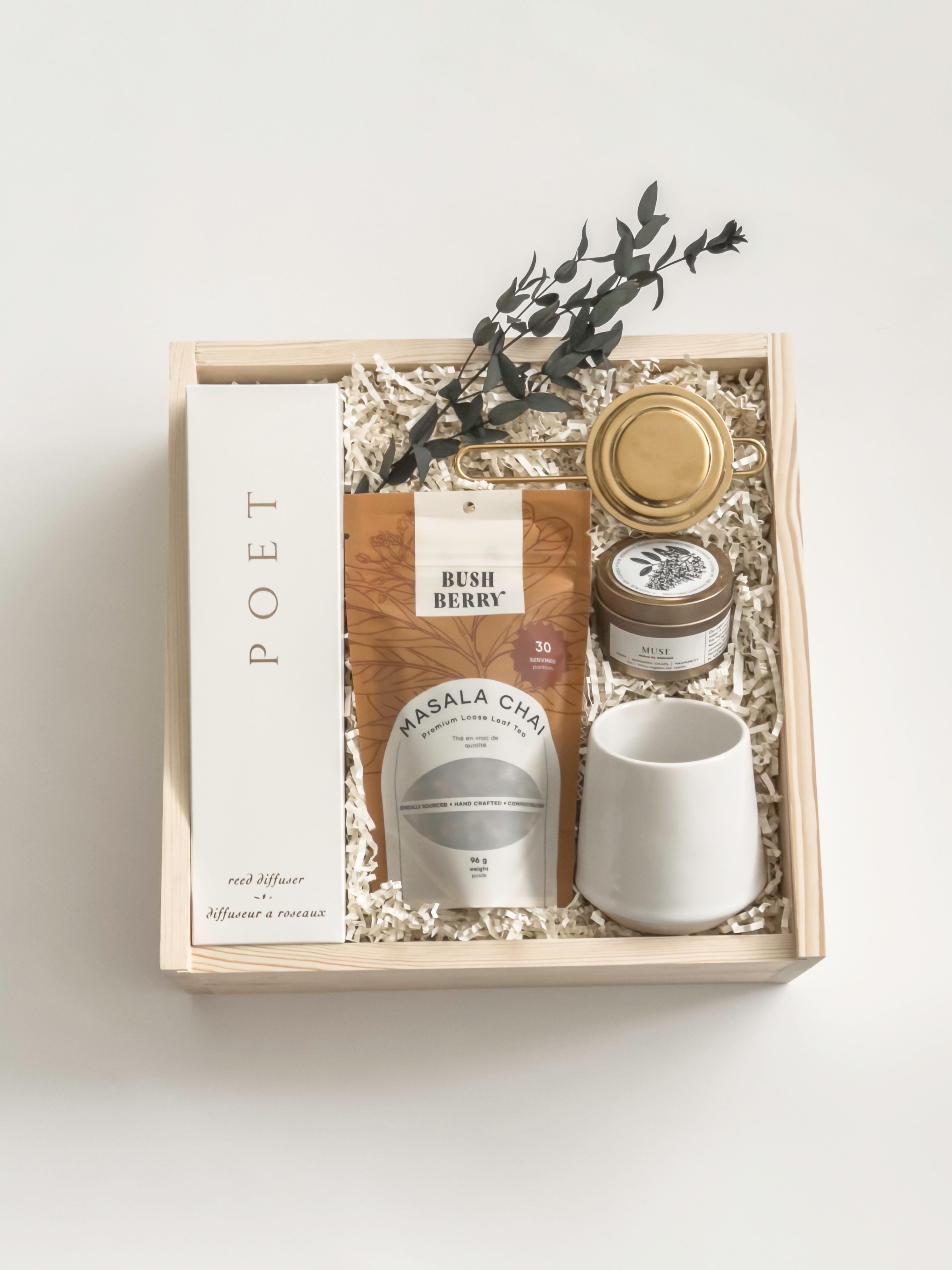 Warm Welcome new homeowner gift with tea, ceramic mug, home fragrance and candle, presented in Muse Baskets and Co.’s Signature Luxe Wood Gift Box.