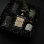 Gift box with crystal whiskey glasses, Amaretto, maple syrup, and Castelvetrano olives.