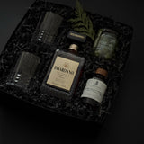 Gift box with crystal whiskey glasses, Amaretto, maple syrup, and Castelvetrano olives.
