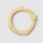 Yellow silicone teething ring on a light gray background